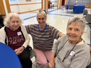 Photo of 3 people seated at a table.